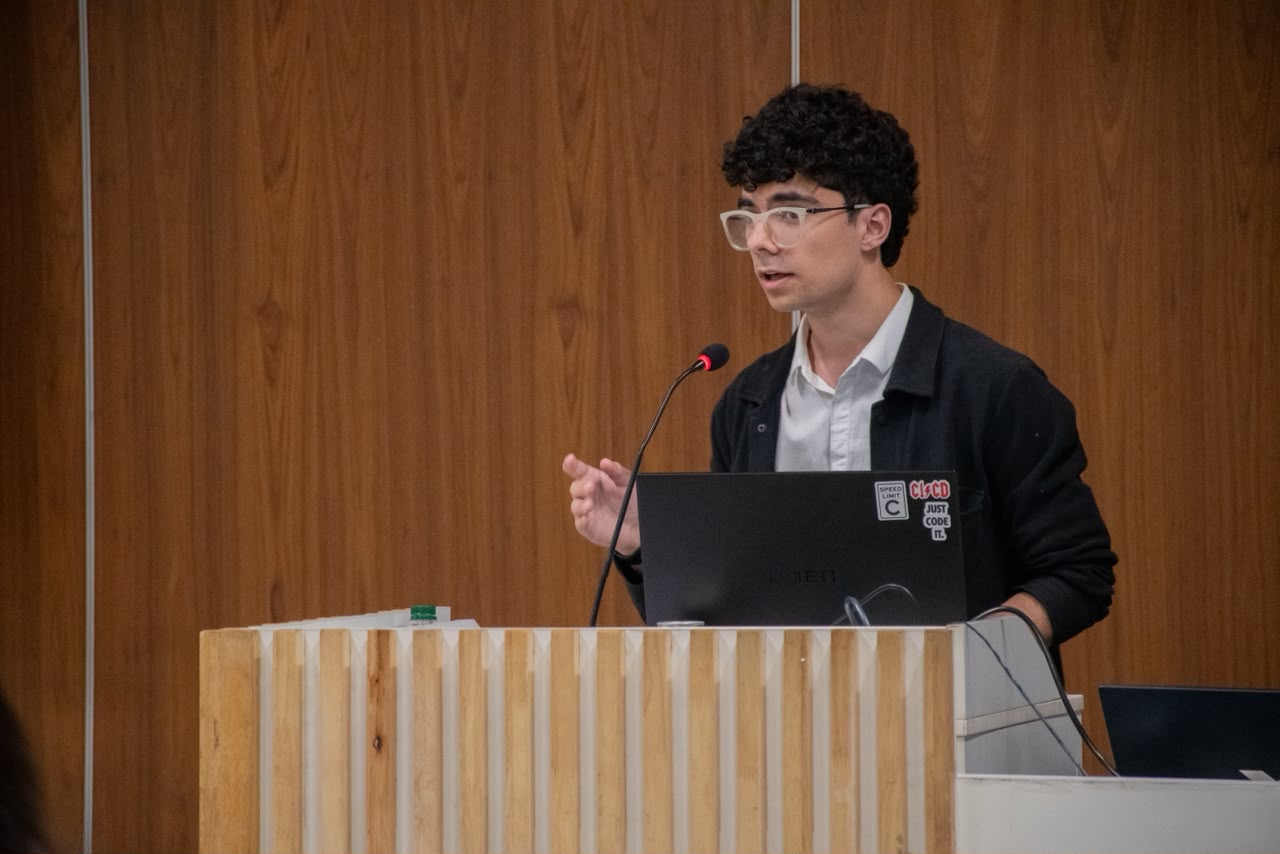 Saurya speaking at a podium